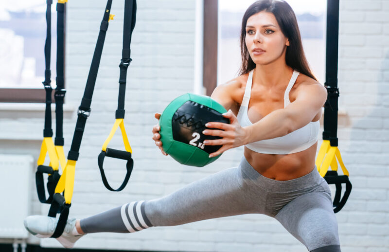 Young adult girl doing exercises in the gym, healthy life